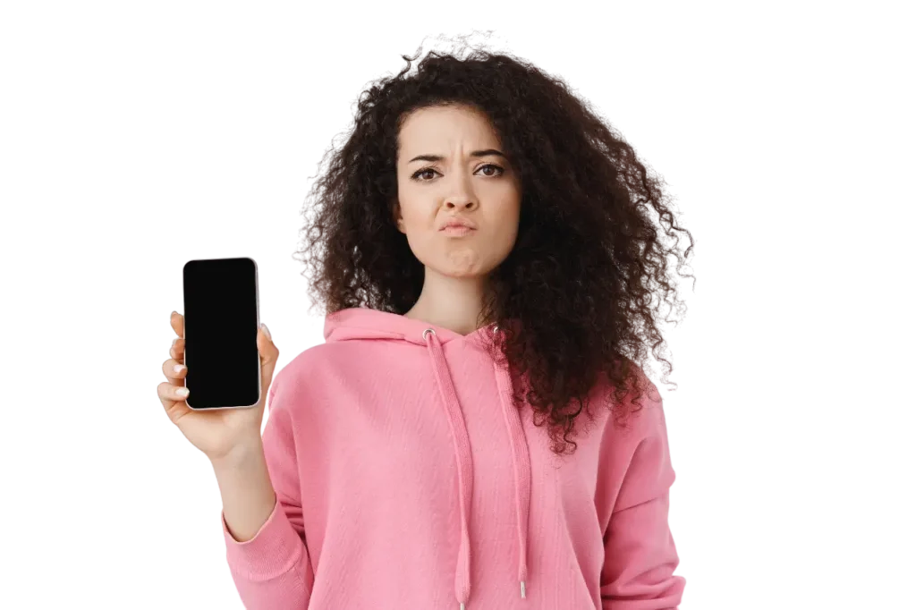 skeptical brunette woman complaining showing empty mobile screen grimacing upset disappointed by smartphone app standing pink hoodie against white backgrou